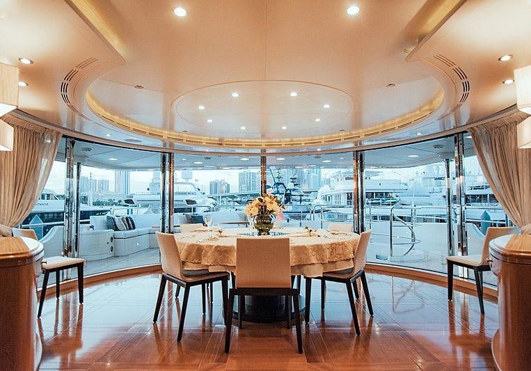 a large room with a table and chairs aboard ALEGRIA Yacht for Charter