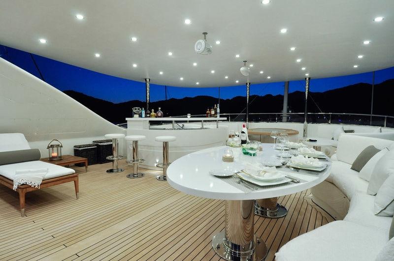 a room with a table and chairs aboard GRANDE AMORE Yacht for Charter