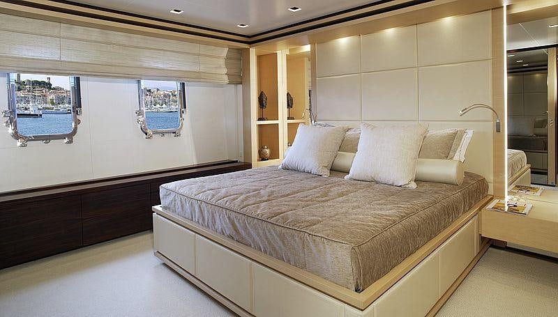 a large bed in a room aboard LAMMOUCHE Yacht for Charter