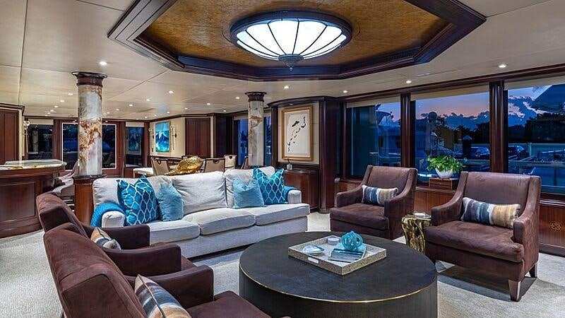 a living room with a large window aboard STARSHIP Yacht for Charter