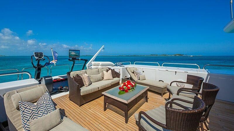 a large patio with a table and chairs on it aboard STARSHIP Yacht for Charter