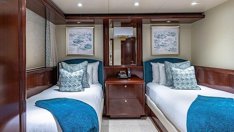 a couple of beds in a hotel room aboard STARSHIP Yacht for Charter
