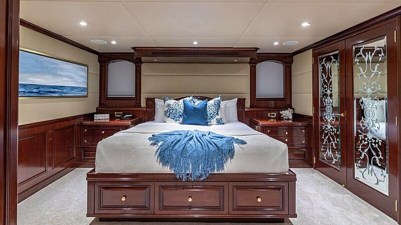 a bedroom with a large bed aboard STARSHIP Yacht for Charter