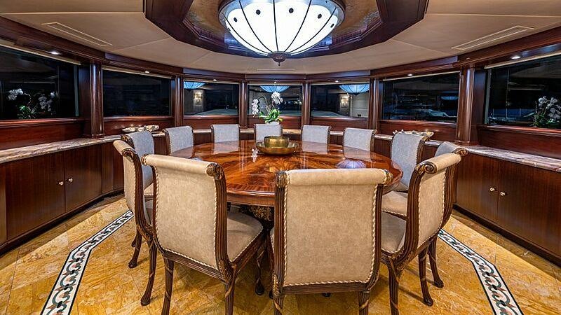 a dining room with a table and chairs aboard STARSHIP Yacht for Charter