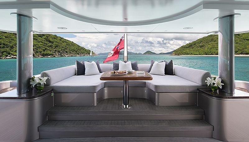 a room with a couch and a table and a flag aboard MUCHOS MAS Yacht for Charter