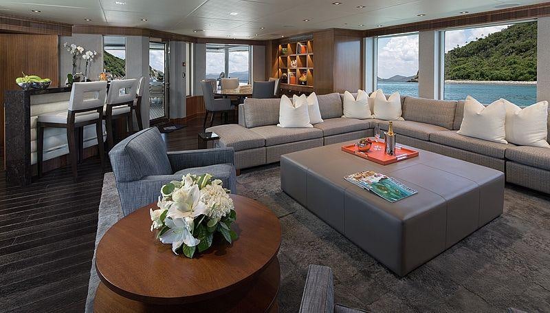 a living room with a couch and a table aboard MUCHOS MAS Yacht for Charter
