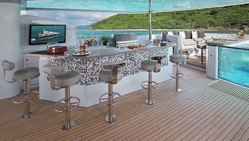 a room with tables and chairs aboard MUCHOS MAS Yacht for Charter
