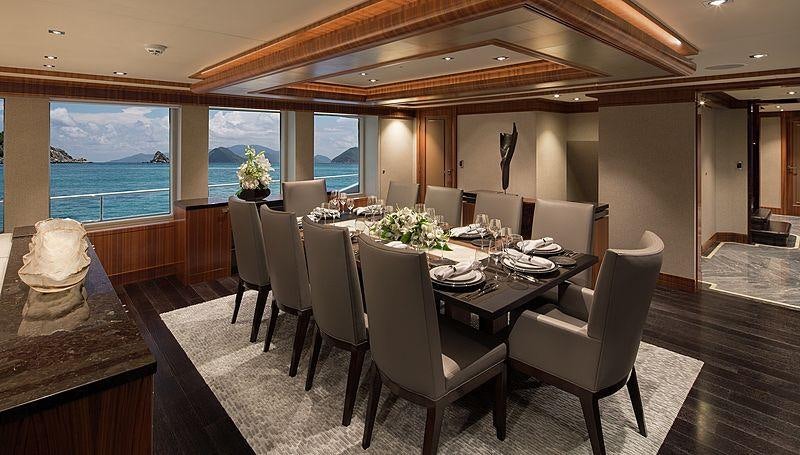 a dining room with a large window aboard MUCHOS MAS Yacht for Charter