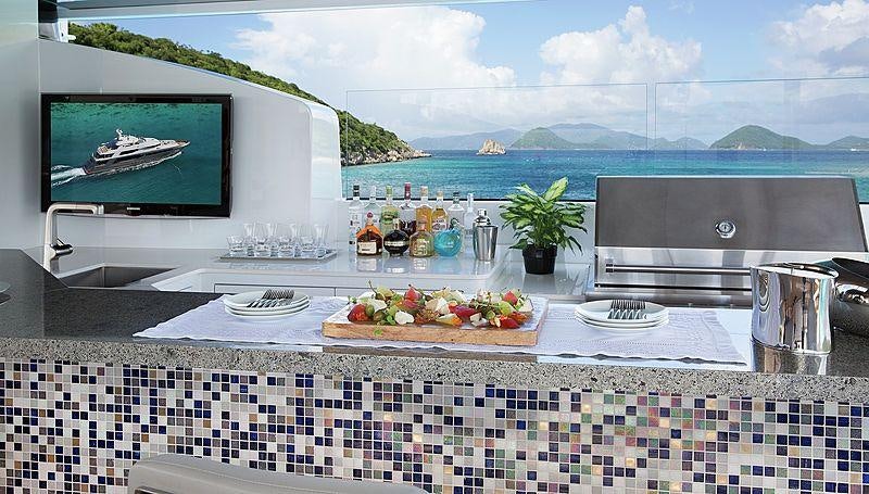 a kitchen with a large window overlooking the ocean aboard MUCHOS MAS Yacht for Charter