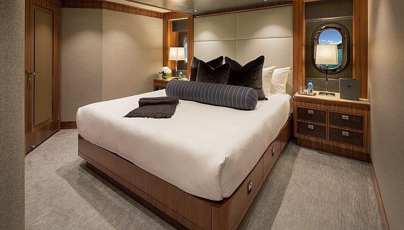 a hotel room with a bed aboard MUCHOS MAS Yacht for Charter