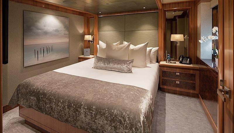a large bed in a hotel room aboard MUCHOS MAS Yacht for Charter