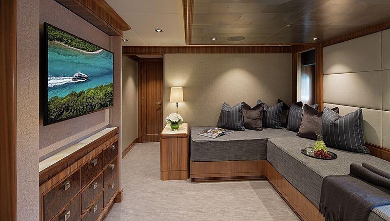a large living room with a large bed and a large painting aboard MUCHOS MAS Yacht for Charter