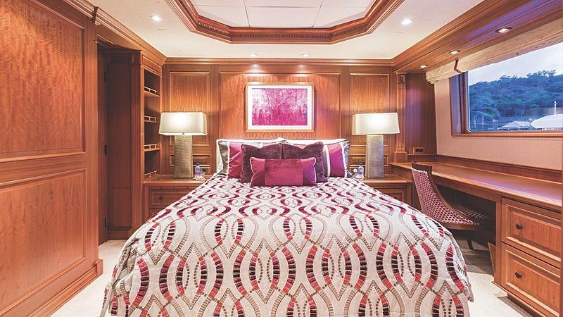 a large bed in a room aboard CROSSED SABRE Yacht for Charter
