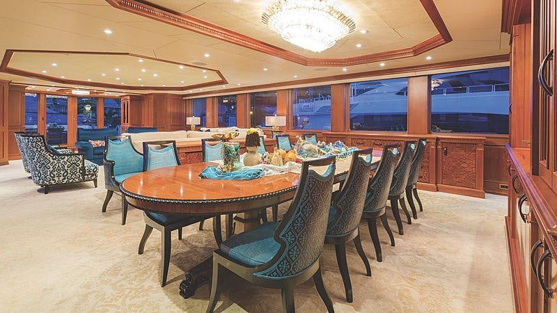 a large room with a table and chairs aboard CROSSED SABRE Yacht for Charter
