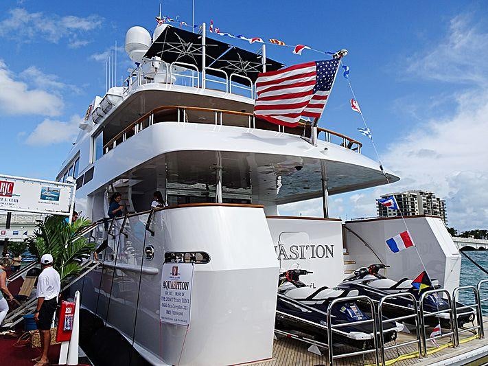 a boat with a flag on the front aboard AQUASITION Yacht for Charter