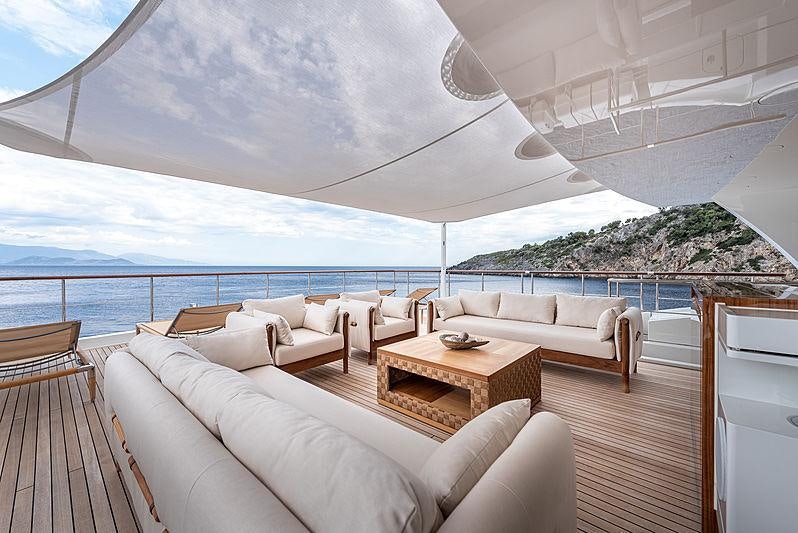 a large white room with a large balcony overlooking the ocean aboard SUNRISE Yacht for Charter