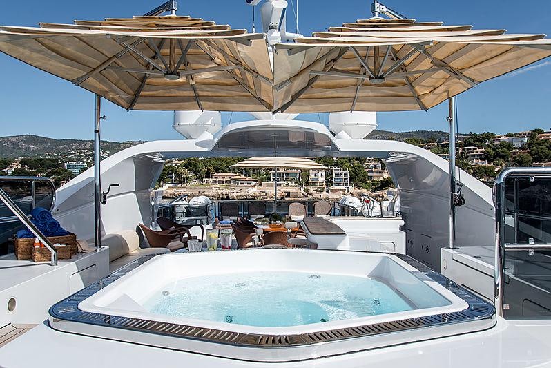 a large white building with a swimming pool and a large white roof aboard DIANE Yacht for Charter