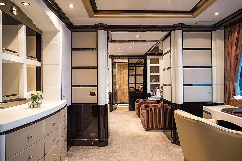 a room with a bed and desk aboard DIANE Yacht for Charter