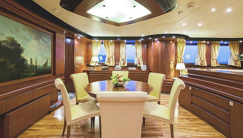 a room with a table and chairs aboard HOLIDAY Yacht for Charter