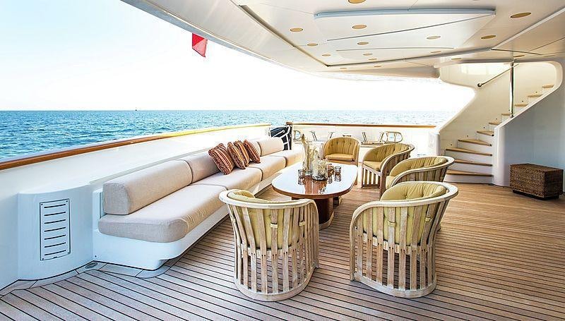 a large living room with a large balcony overlooking the ocean aboard HOLIDAY Yacht for Charter