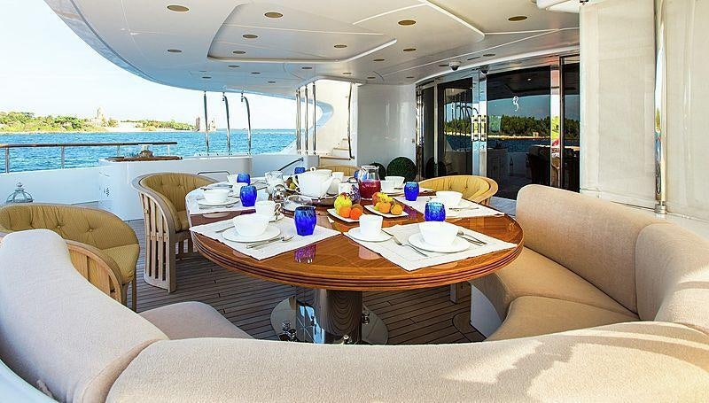 a large dining table with a view of the ocean aboard HOLIDAY Yacht for Charter