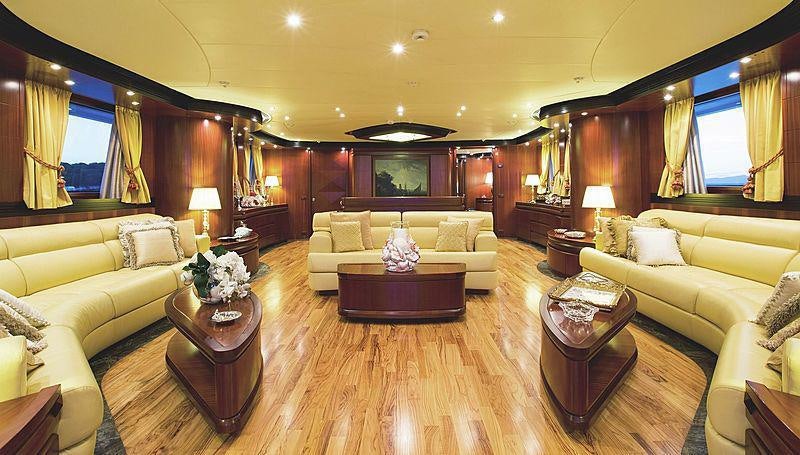 a living room with a large wood floor aboard HOLIDAY Yacht for Charter