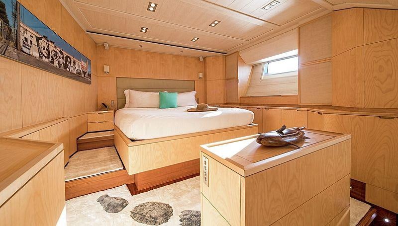 a room with a bed and a desk aboard GUILLEMOT Yacht for Charter