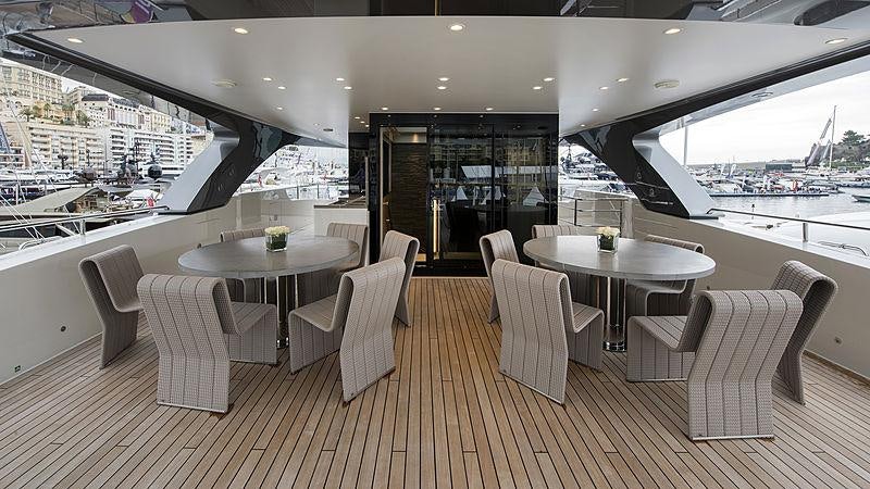 a room with a table and chairs aboard X Yacht for Charter