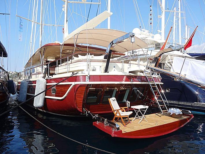 a boat docked in a harbor aboard DAIMA Yacht for Charter