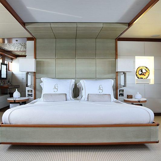 a bed with a white bed spread aboard LIFE SAGA Yacht for Charter