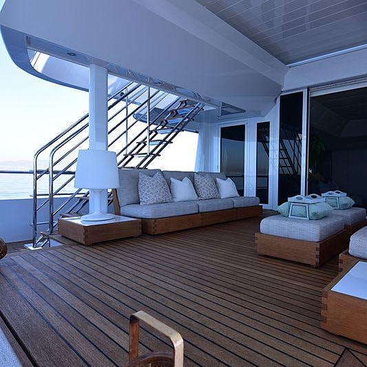 a large living room with a large staircase aboard LIFE SAGA Yacht for Charter