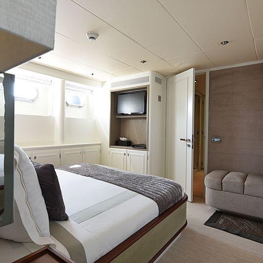 a bedroom with a bed and a couch aboard LIFE SAGA Yacht for Charter