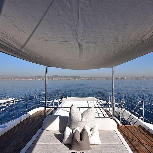 a lounge chair on a deck overlooking the ocean aboard LIFE SAGA Yacht for Charter
