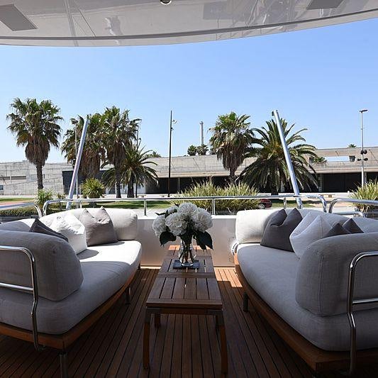 a patio with a table and chairs aboard LIFE SAGA Yacht for Charter