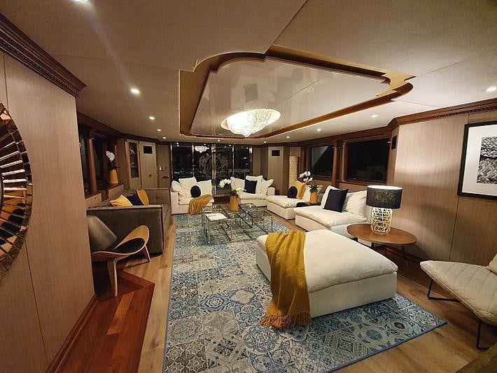 a living room with a large chandelier aboard IRAMA Yacht for Charter