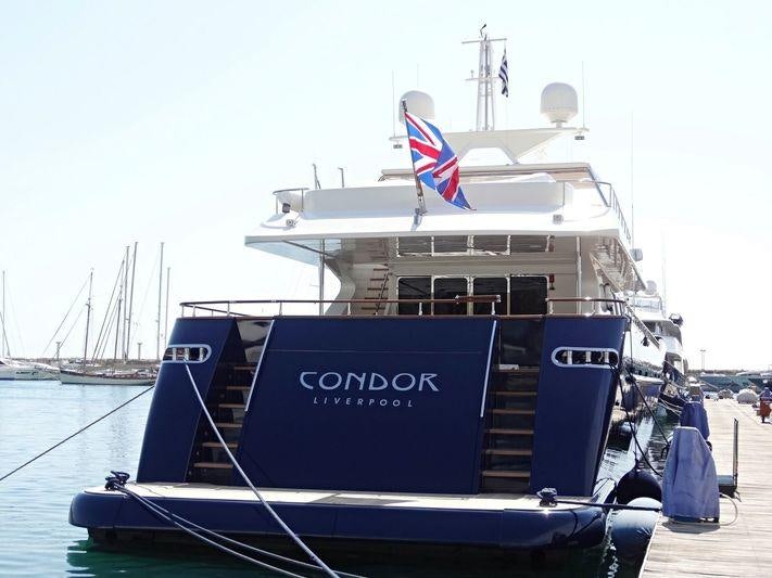 a large boat with a flag on it aboard CONDOR A Yacht for Charter
