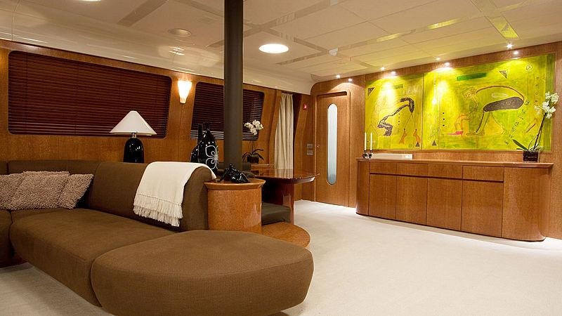 a room with a couch and a table and a lamp aboard CONDOR A Yacht for Charter