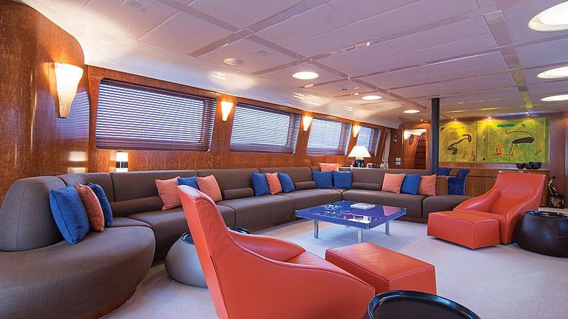 a living room with a couch and a table aboard CONDOR A Yacht for Charter