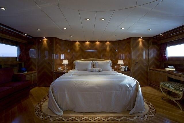 a large bed in a room aboard LADY G II Yacht for Charter