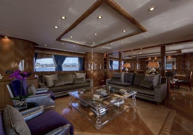 a living room with a large wood floor and a large window aboard LADY G II Yacht for Charter