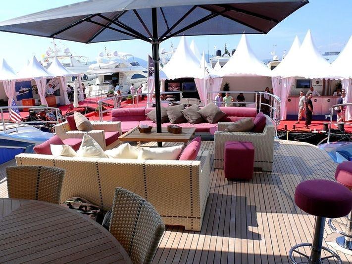 a group of tables and chairs under an umbrella aboard WAVERUNNER Yacht for Charter