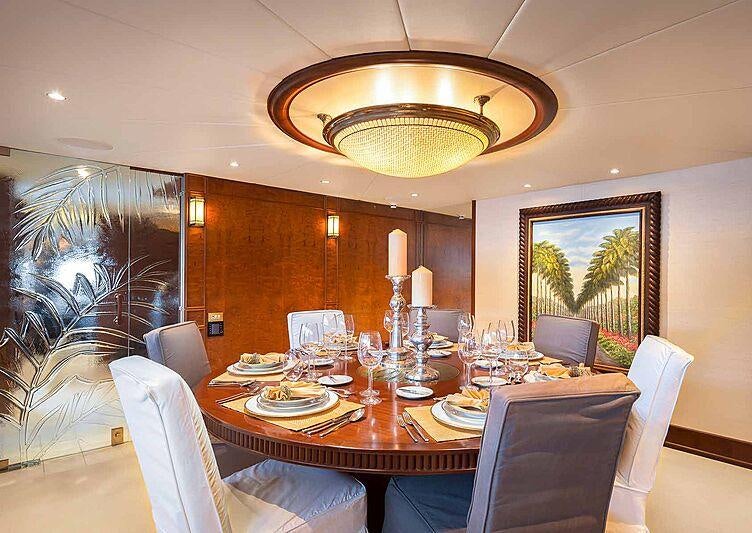 a dining room with a chandelier aboard BRAZIL Yacht for Charter
