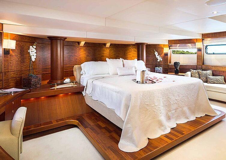 a room with a bed and a table aboard BRAZIL Yacht for Charter