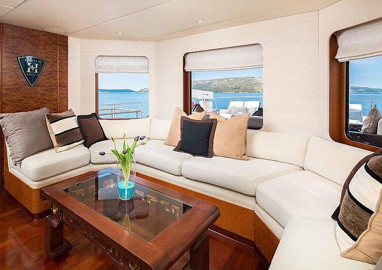 a living room with a white couch and a coffee table aboard BRAZIL Yacht for Charter