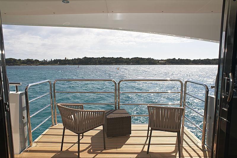 a deck with chairs on it and water in the background aboard IMPERIAL PRINCESS BEATRICE Yacht for Charter