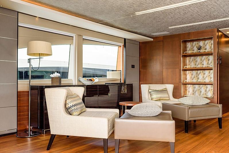 a living room with a large window aboard IMPERIAL PRINCESS BEATRICE Yacht for Charter