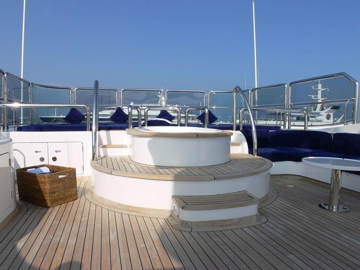 a white bed on a deck aboard DESAMIS B Yacht for Charter