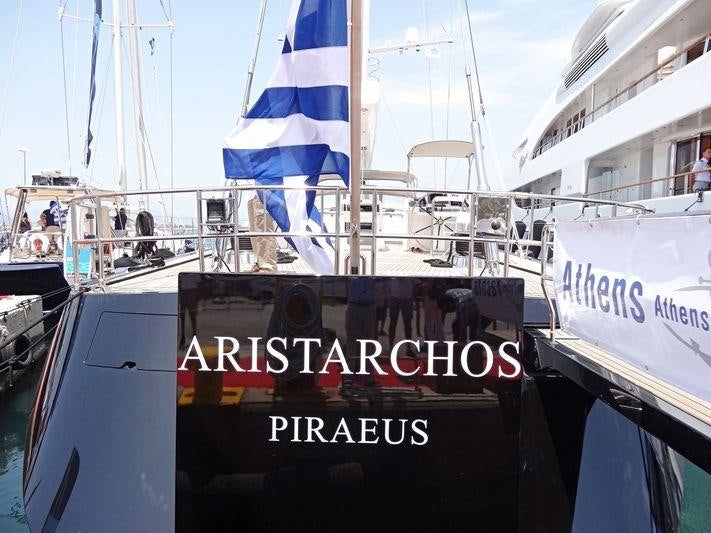 a boat with a flag on the front aboard ARISTARCHOS Yacht for Charter