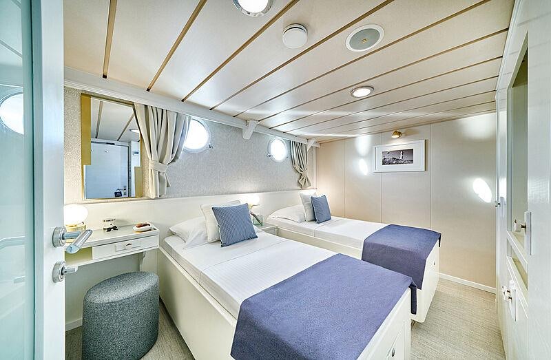 a room with two beds aboard LA PERLA Yacht for Charter