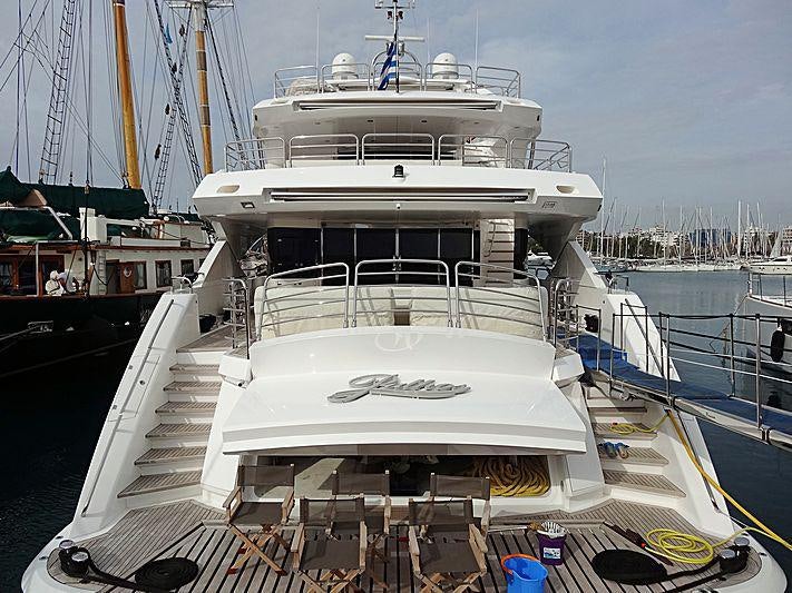 a large white boat docked aboard PATHOS Yacht for Charter